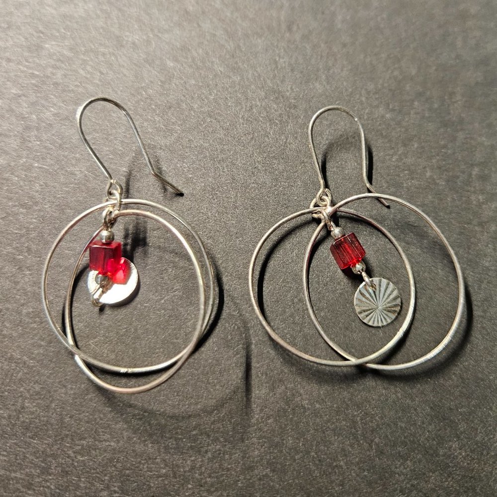 Silver tone earrings with red glass bead